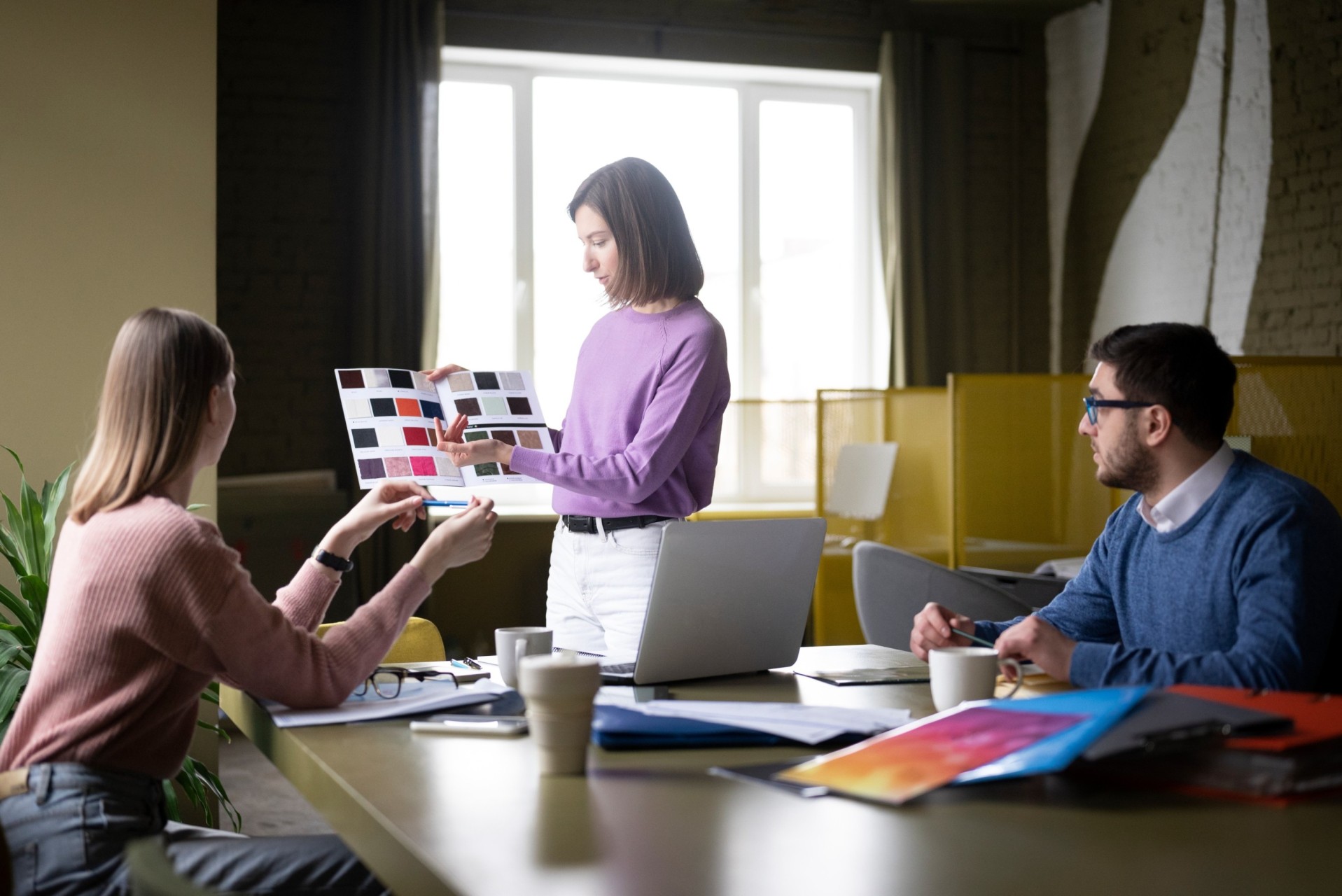 A professional looking at a set of beautifully designed marketing materials.